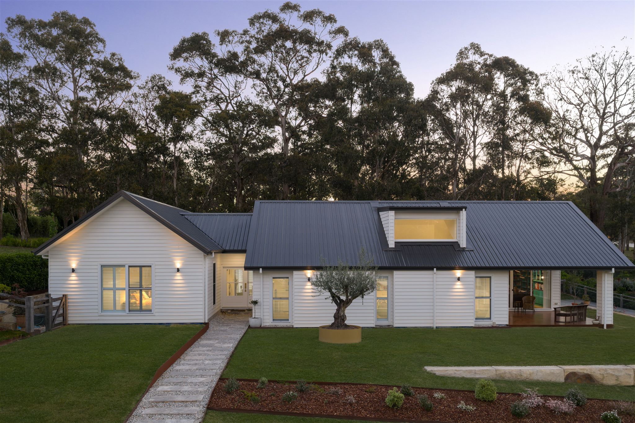 Photograph of a white Australian home in Bundanoon with a dark metal roof